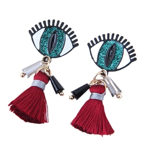 Evil eye earrings with green glitter pupil and long red silk tassels on white background