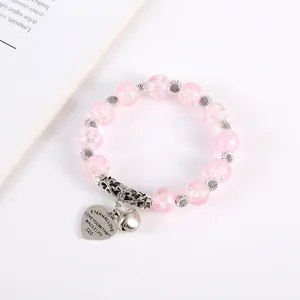Detail of pink cracked crystal bracelet with sunflower spacers and Eternal Love heart charm