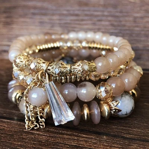 Bohemian multi-layer elastic beaded bracelet set with crystal charms on wood