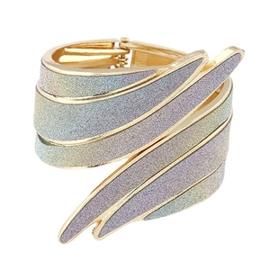 Punk style gold open bangle with layered wings and iridescent glitter finish