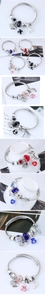 Detail of beaded cable bracelets featuring moon and heart charms with crystals