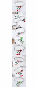 Detail view of steel wire bracelet with cherry charms and colorful beads on white background