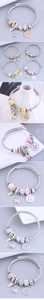 Detail of silver woven bracelet with enamel bear charms and colorful beaded pendants