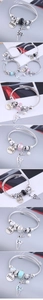 Detail of twisted cable bracelet featuring LOVE disc, hollow deer charm and colored beads