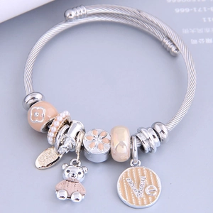 Silver stainless steel wire bracelet with cute bear charm and pink enamel flower beads