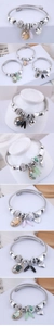 Detail of beaded bracelets with heart charms, crystals and pearls in various colors