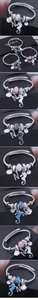 Detail of nautical wire bracelets with seahorse, shell, and crystal charms on jewelry box