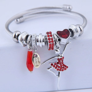 Beaded steel wire bracelet with red ballet dancer charm and heart pendant on white box