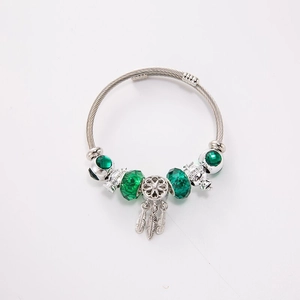 Silver cable charm bracelet with green crystal beads and dreamcatcher feather pendant