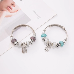 Silver bead bracelets with dreamcatcher and feather charms in blue and purple styles