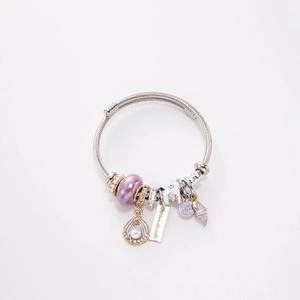 Detail of twisted wire bracelet with purple beads, shell charms, and LOVE engraving