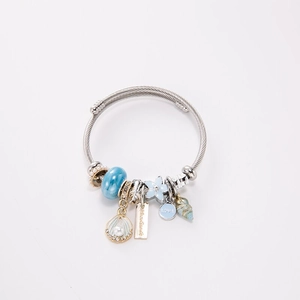 Silver stainless steel wire bracelet with blue glass beads and shell charms