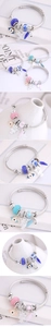 Macro shot of owl charm and evil eye beads on adjustable stainless steel bracelet