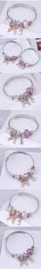 Detail of silver twisted rope bracelets with butterfly charms and longevity beads