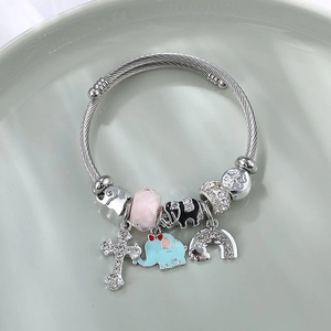 Silver beaded wire bracelet with charms featuring cross, elephant, and rainbow motifs