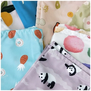 Detailed close-up of cartoon pattern cooling arm sleeves with zigzag hem stitching