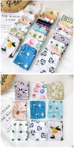 Detailed flat lay of colorful cartoon printed ice silk cooling arm sleeves for summer sun protection