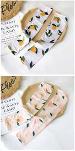 Close-up of ice silk cooling sleeves with orange and peach patterns on a tray