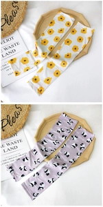 Detail view of cartoon cooling sleeves with floral and panda prints for sun protection