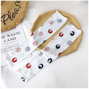 Detail of white cooling sleeves with cartoon duck prints and breathable ice silk texture