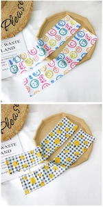Detail of ice silk sun protection sleeves with colorful smiley face and plaid patterns