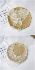 Detail showing cream lace embroidery shawl with floral patterns and drawstring tie