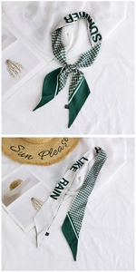 Close-up of green polka dot and houndstooth silk ribbon scarf with Summer printed text