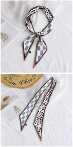 Detail of leopard and checkerboard print twilly scarf with elegant pointed ends