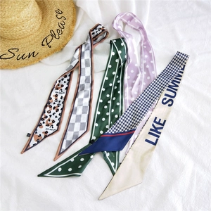 Polka dot and leopard print skinny silk scarves set on a summer sun hat background
