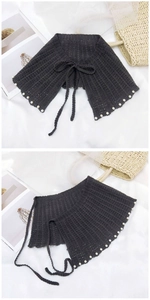 Détail d'un châle en tricot avec bordure en perles et lien ajustable pour femme