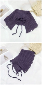 Détail d'un châle tricoté violet avec bordure en perles et nœud décoratif