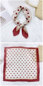 Detailed view of beige polka dot cotton linen square scarf with red borders on white background