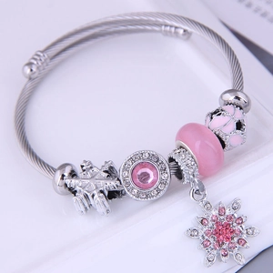 Bohemian silver twisted steel bracelet with pink crystals, snowflakes, and charms