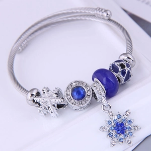 Bohemian style beaded bracelet with snowflake charms and blue stones on stainless steel