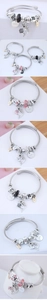 Detailed close-up of bohemian dolphin charms and crystal beads on a stainless steel bangle