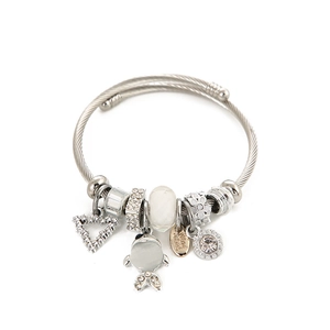 Silver beaded bracelet with crystal fish, heart charms and handmade tag on white background
