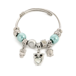 Silver woven stainless steel bangle with blue beads and owl owl turtle charms