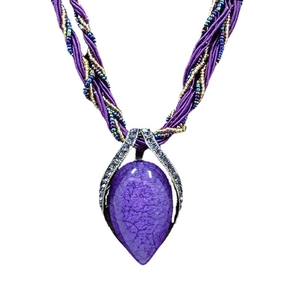 Bohemian purple teardrop stone necklace with intricate beaded silk cord on white background