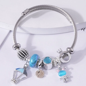 Beaded charm bracelet with blue cat eye rabbit, hot air balloon and crown accents