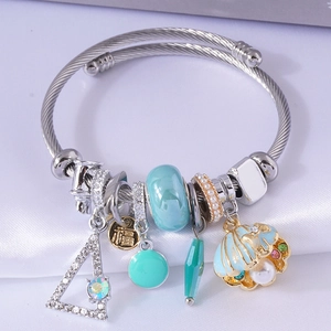Silver cable cuff bracelet featuring colorful crystal charms and a shell pearl pendant