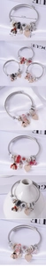 Detailed close-up of adjustable steel charm bracelets with crystal hearts and enamel beads