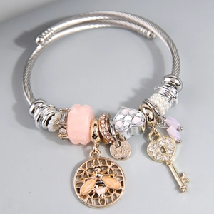Adjustable steel wire bracelet featuring bee, key, and pink heart charms in silver finish