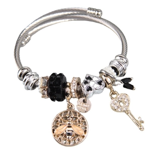 Silver charm bracelet with bee and heart key pendants and black faceted beads