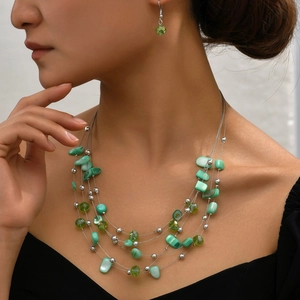 Bohemian multilayer green beaded necklace and earring set with shell stones on model