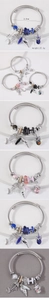 Detailed view of silver nautical charm bracelet with fishbone, starfish, and shell charms