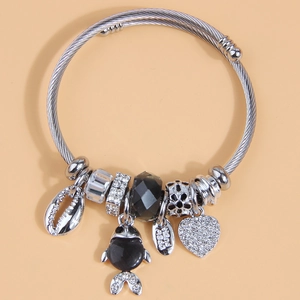 Silver braided charm bracelet with heart, black fish, shell charms and Lucky tag