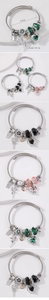 Macro shot of a wire bangle bracelet with heart crystals and fairy charms details