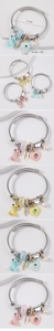 Detail of beaded stainless steel wire bracelet with bear, heart, and pearl charms
