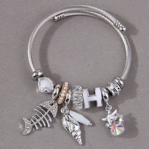 Stainless steel charm bracelet featuring starfish, seashell, pearl, and crystal bead accents