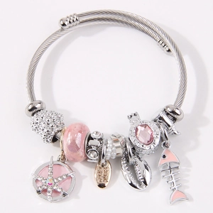Silver bead bracelet with pink fishbone, starfish, and shell charms on white background